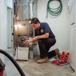 HVAC technician inspecting a furnace not blowing air inside a San Francisco home